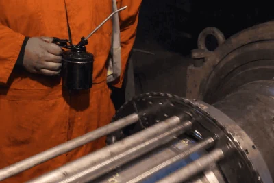 Technician performing in-situ journal machining on large installed industrial engine